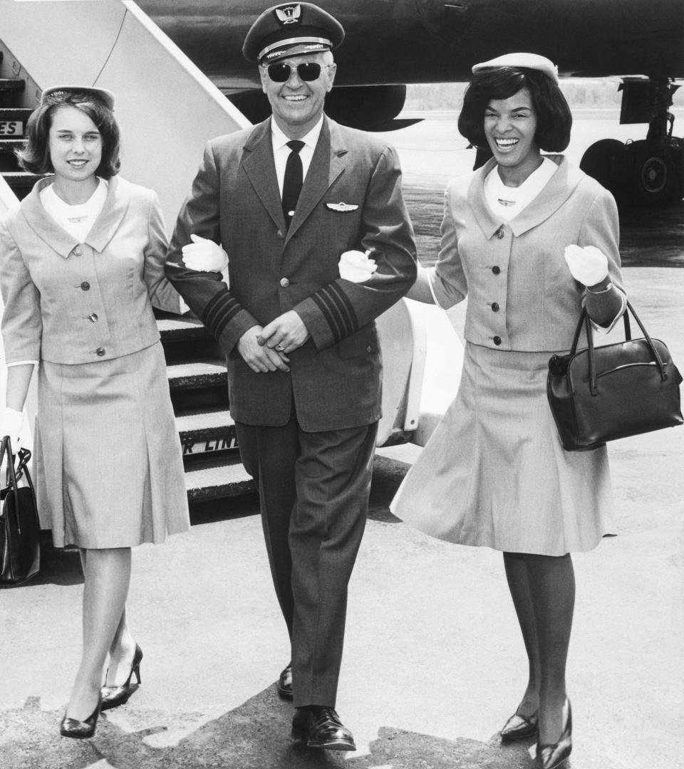 United Airlines&rsquo; Capt. L.L. Treece escorts stewardesses Carol DiPasalegne and JoAnn Tartaul to the crew lounge after&nbsp;a trip from Chicago in 1965.