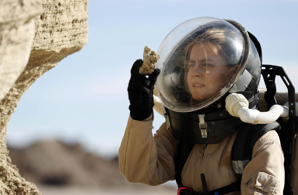 Csilla Orgel, a geologist with Crew 125 EuroMoonMars B mission, collects geologic samples for study at the Mars Desert Research Station (MDRS) outside Hanksville in the Utah desert March 2, 2013. The MDRS aims to investigate the feasibility of a human exploration of Mars and uses the Utah desert's Mars-like terrain to simulate working conditions on the red planet. Scientists, students and enthusiasts work together developing field tactics and studying the terrain. All outdoor exploration is done wearing simulated spacesuits and carrying air supply packs and crews live together in a small communication base with limited amounts of electricity, food, oxygen and water. Everything needed to survive must be produced, fixed and replaced on site. Picture taken March 2, 2013. REUTERS/Jim Urquhart