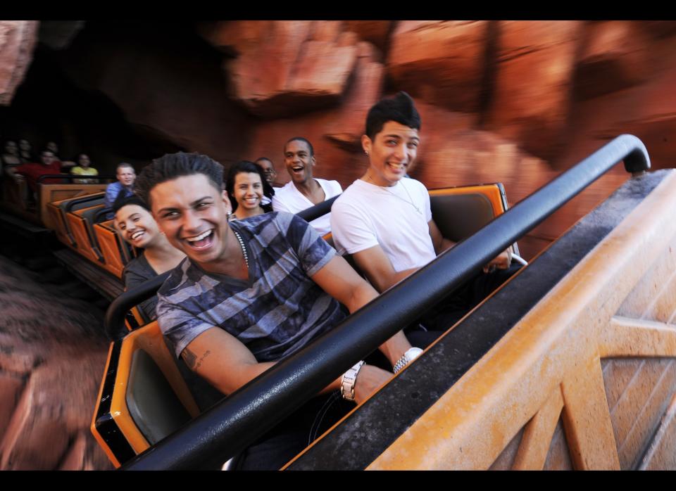 Paul "DJ Pauly D"  Delvecchio from the MTV series "Jersey Shore," rides the Big Thunder Mountain Railroad roller coaster with Celebration (Fla.) High School senior Bryan Lopez, right,  during an appearance at the Magic Kingdom, Friday, Oct. 22, 2010 in Lake Buena Vista, Fla. (AP Photo/Disney, Diana Zalucky)