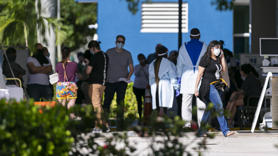 People line up to enter a triage tent outside of the emergency room at Memorial West Hospital in Pembroke Pines, Fla., on Monday, March 16, 2020. (Matias J. Ocner/Miami Herald/Tribune News Service via Getty Images)