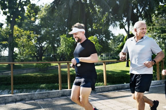 Two men jogging in the park.