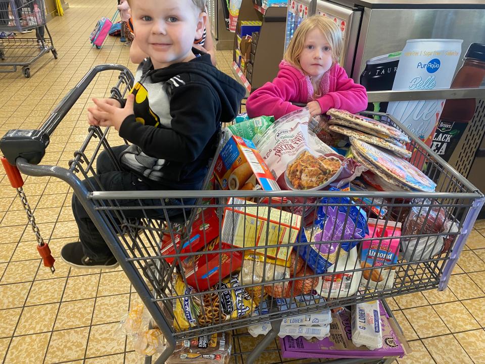 cart full of groceries and two kids with it in aldi