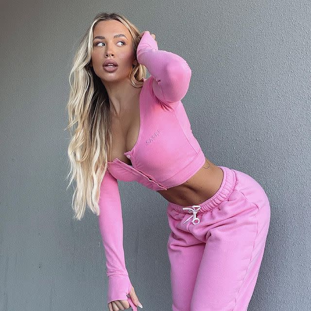 Tammy Hembrow models a pink top and matching trackpants from her fashion brand Saski's 'Faded' collection