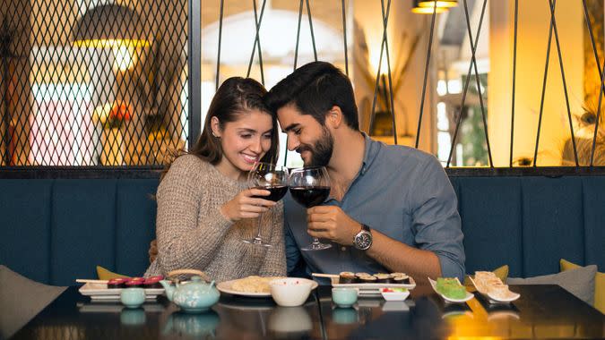 Young couple in a restaurant, drinking wine.