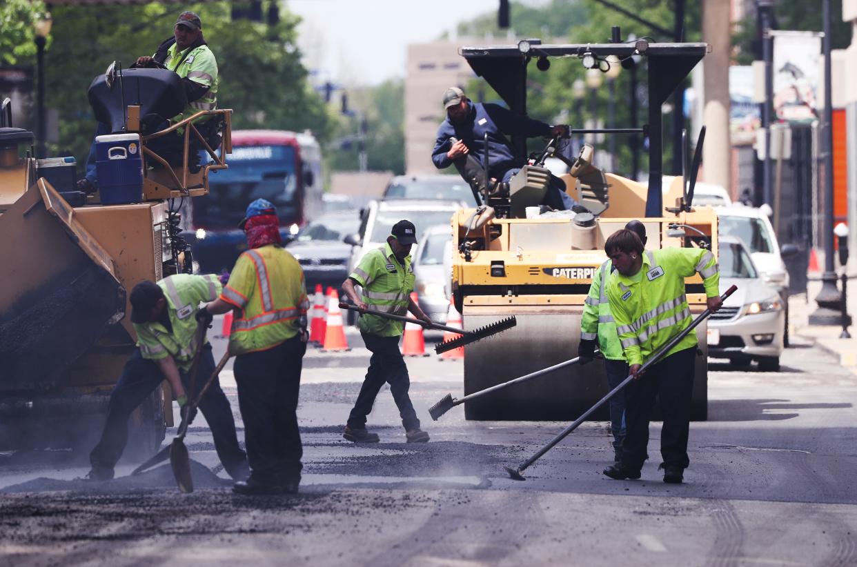 A work crew paves a road at 3rd and Liberty streets in downtown Louisville, Ky. on April 24, 2020.