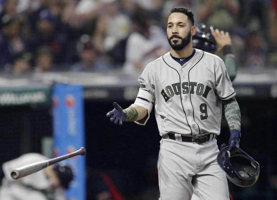 FILE - In this Saturday, May 26, 2018 file photo, Houston Astros' Marwin Gonzalez throws his bat after striking out against Cleveland Indians starting pitcher Carlos Carrasco during the fifth inning of a baseball game in Cleveland. Marwin Gonzalez became the first batter from the 2017 Houston Astros team that won the World Series to publicly apologize for his role in the sign-stealing scandal, expressing regret Tuesday, Feb. 11, 2020 after reporting to spring training with the Minnesota Twins.(AP Photo/Tony Dejak, File)