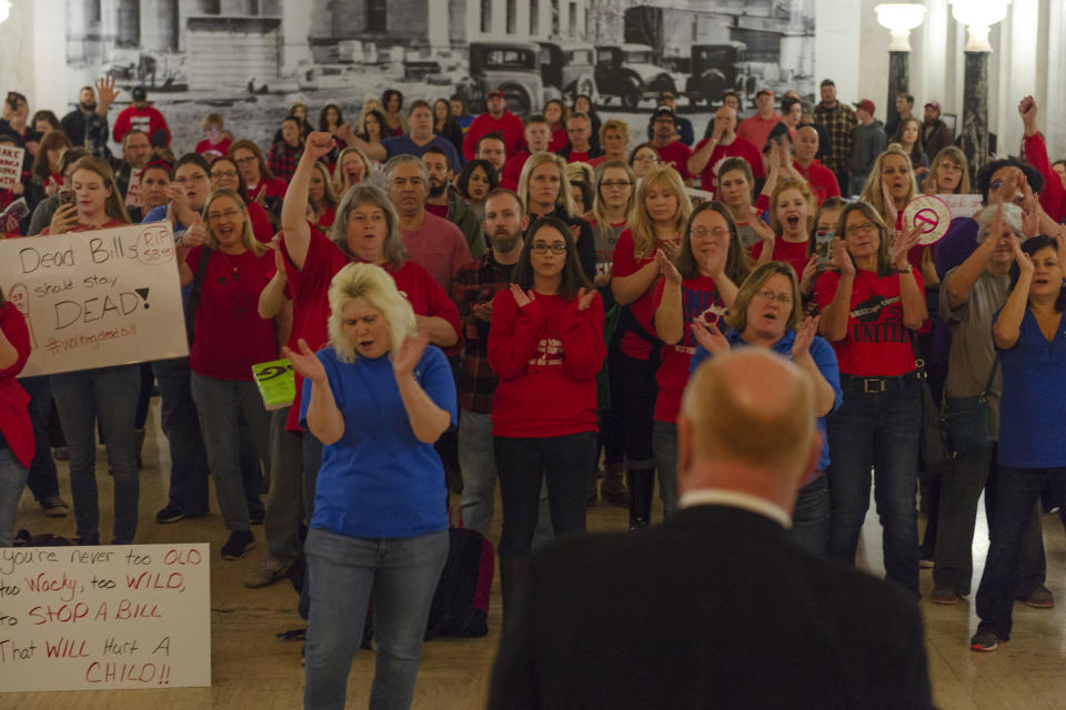 Teachers and school personnel clap as West Virginia Education Association President Dale Lee speaks in front of the House of Delegates chamber at the West Virginia State Capitol in Charleston, W.Va. on the second day of a statewide strike by teachers and school personnel on Tuesday, February 20, 2019. (Craig Hudson/Charleston Gazette-Mail via AP)