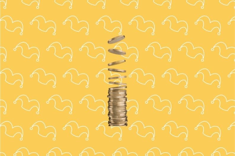 A stack of coins against a yellow background