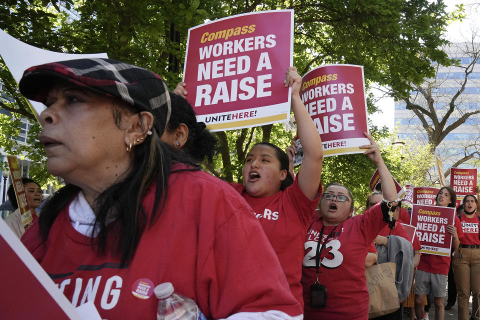 Workers who are contracted to feed World Bank employees through a firm called the Compass Group, protest for higher wages and affordable healthcare benefits, Wednesday, April 12, 2023, outside of the World Bank in Washington. (AP Photo/Mariam Zuhaib)