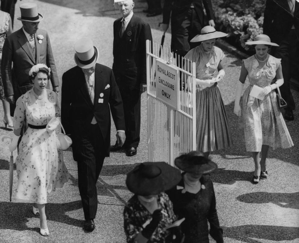 File photo dated 13/07/55 o Queen Elizabeth II and Princess Margaret (right), walking into the paddock at the Royal Ascot race meeting.