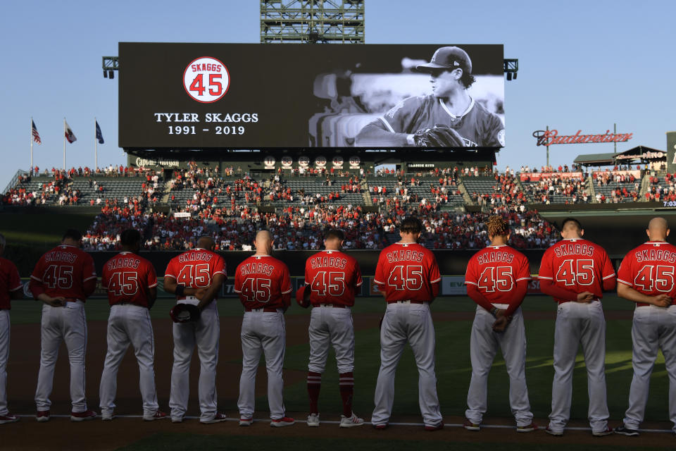 ANAHEIM, CA - JULY 12: The Los Angeles Angels of Anaheim stand for a moment of silence before they play the Seattle Mariners at Angel Stadium of Anaheim on July 12, 2019 in Anaheim, California. The entire Angels team wore #45 on their jersey to honor Skaggs who died on July 1. (Photo by John McCoy/Getty Images)