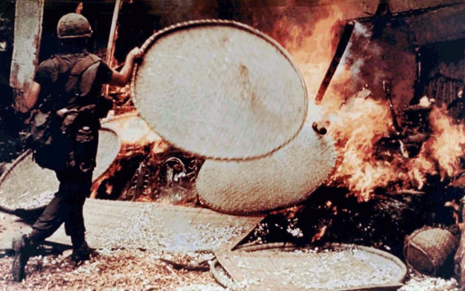 US marine torching a house during the My Lai massacre