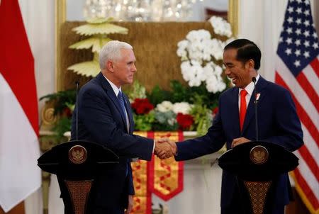 U.S. Vice President Mike Pence shakes hands with Indonesia's President Joko Widodo at the Presidential Palace in Jakarta, Indonesia April 20, 2017. REUTERS/Beawiharta