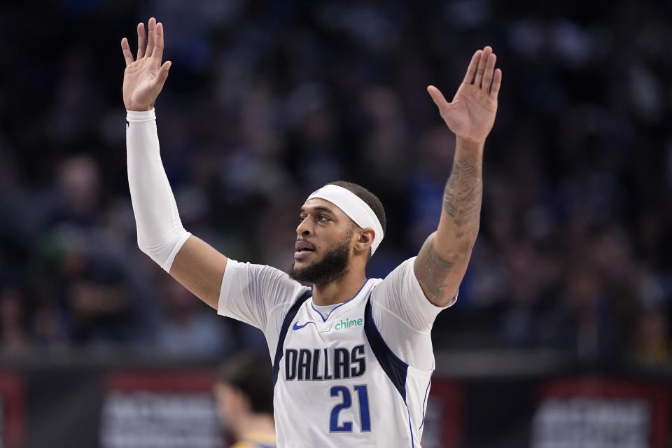 Dallas Mavericks' Daniel Gafford (21) celebrates after dunking against the Golden State Warriors during the first half of an NBA basketball game Wednesday, March 13, 2024, in Dallas. (AP Photo/Tony Gutierrez)