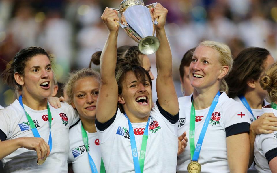 Captain of England Katy McLean lifts the trophy with teammates to celebrate the victory in the IRB Women's Rugby World Cup 2014 Final