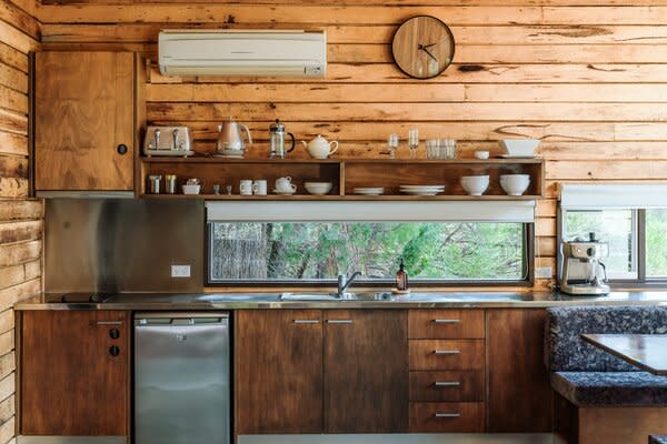 DULC, short for Down Under Log Cabins, is a collection of three private rough-sawn timber cabins—two single level, one double—built on five acres in the Australian bush.