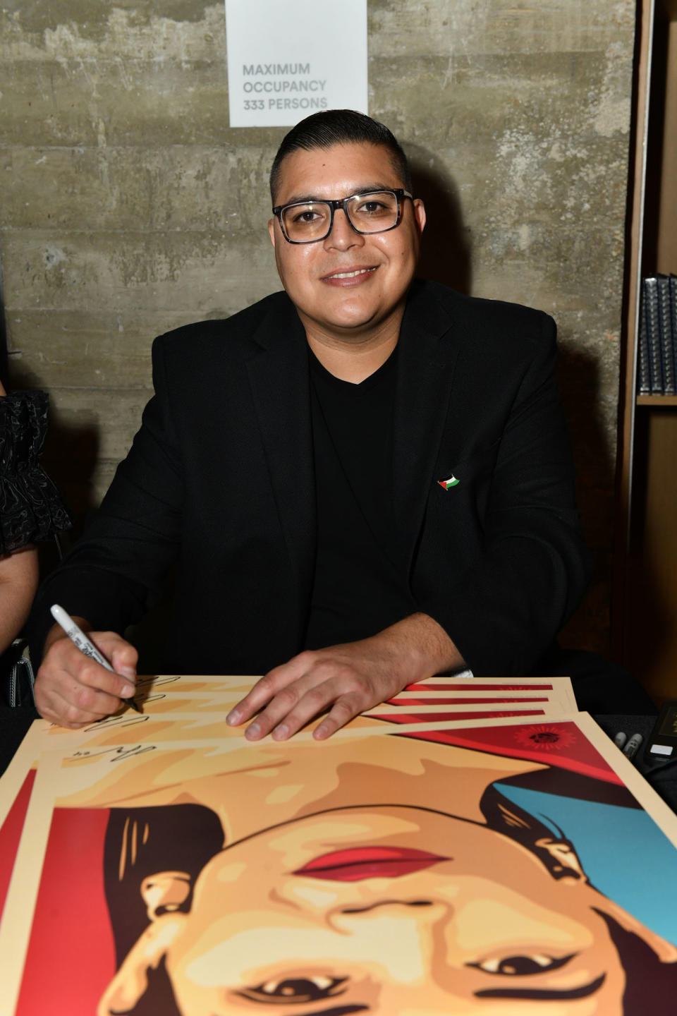 Artist Ernesto Yerena with his painting of America Ferrera for the event. (Craig Barritt / Getty Images for The Latinx Hous)