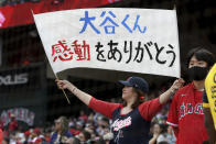 A Los Angeles Angels' fan holds a sign thanking pitcher Shohei Ohtani during a baseball game against the Seattle Mariners, Sunday, Sept. 26, 2021, in Anaheim, Calif. The Mariners won 5-1. (AP Photo/Michael Owen Baker)