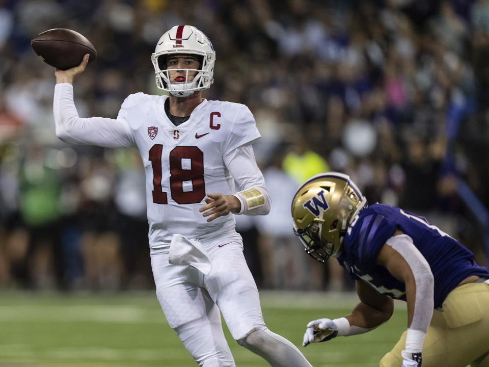 Stanford quarterback Tanner McKee attempts to throw a pass while being pressured by Washington linebacker Daniel Heimuli during the first half of an NCAA college football game Saturday, Sept. 24, 2022, in Seattle. (AP Photo/Stephen Brashear)