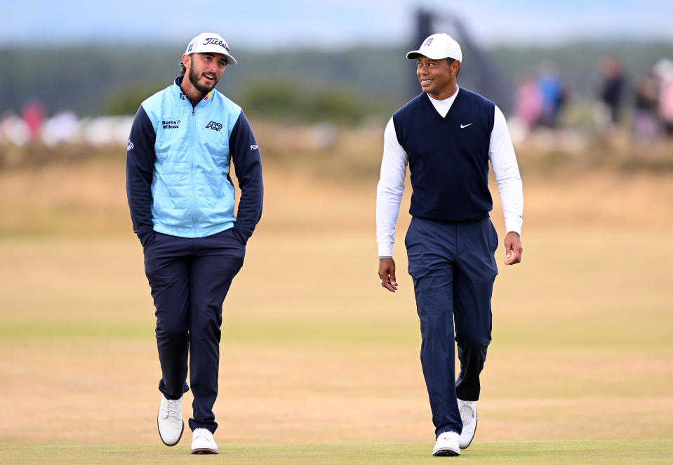 Max Homa and Tiger Woods interact during Day One of The 150th Open at St Andrews Old Course on July 14, 2022 in St Andrews, Scotland. (Photo by Ross Kinnaird/Getty Images)