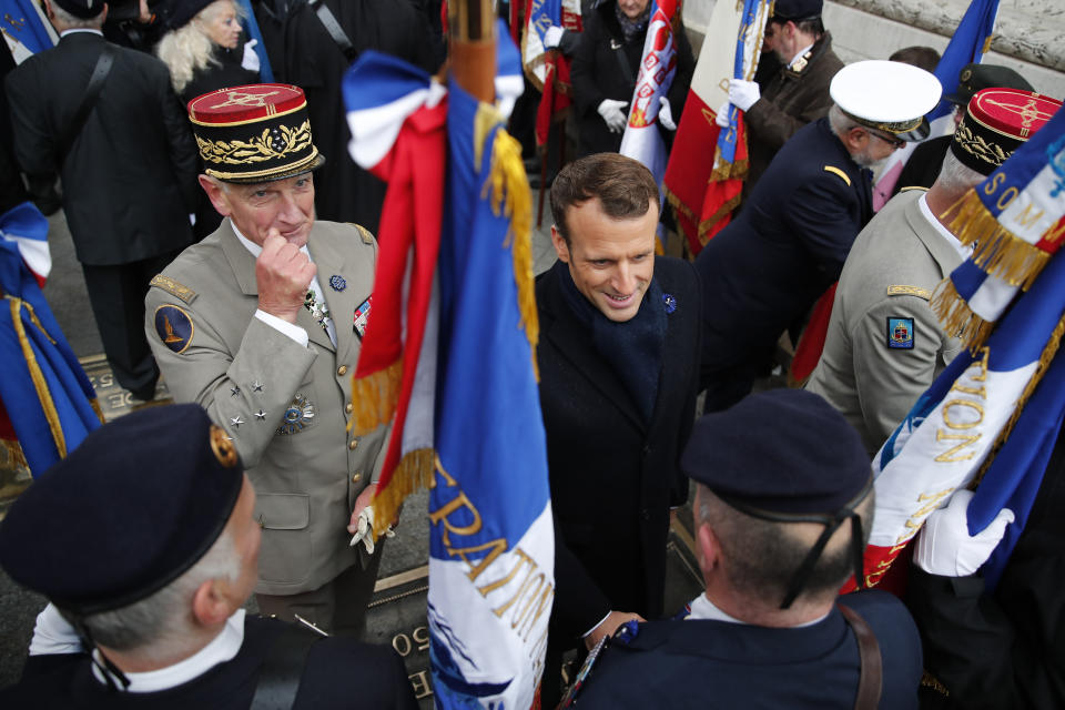 French President Emmanuel Macron with French Armies Chief of Staff General Francois Lecointre, left, meets veterans under the Arc de Triomphe during commemorations marking the 101st anniversary of the 1918 armistice, ending World War I, Monday Nov. 11, 2019 in Paris (AP Photo/Francois Mori, Pool)