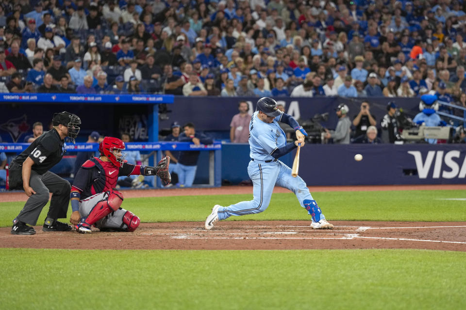 Toronto Blue Jays catcher Danny Jansen (9) hits a home run against the Washington Nationals during the third inning of a baseball game in Toronto on Monday, Aug. 28, 2023. (Andrew Lahodynskyj/The Canadian Press via AP)