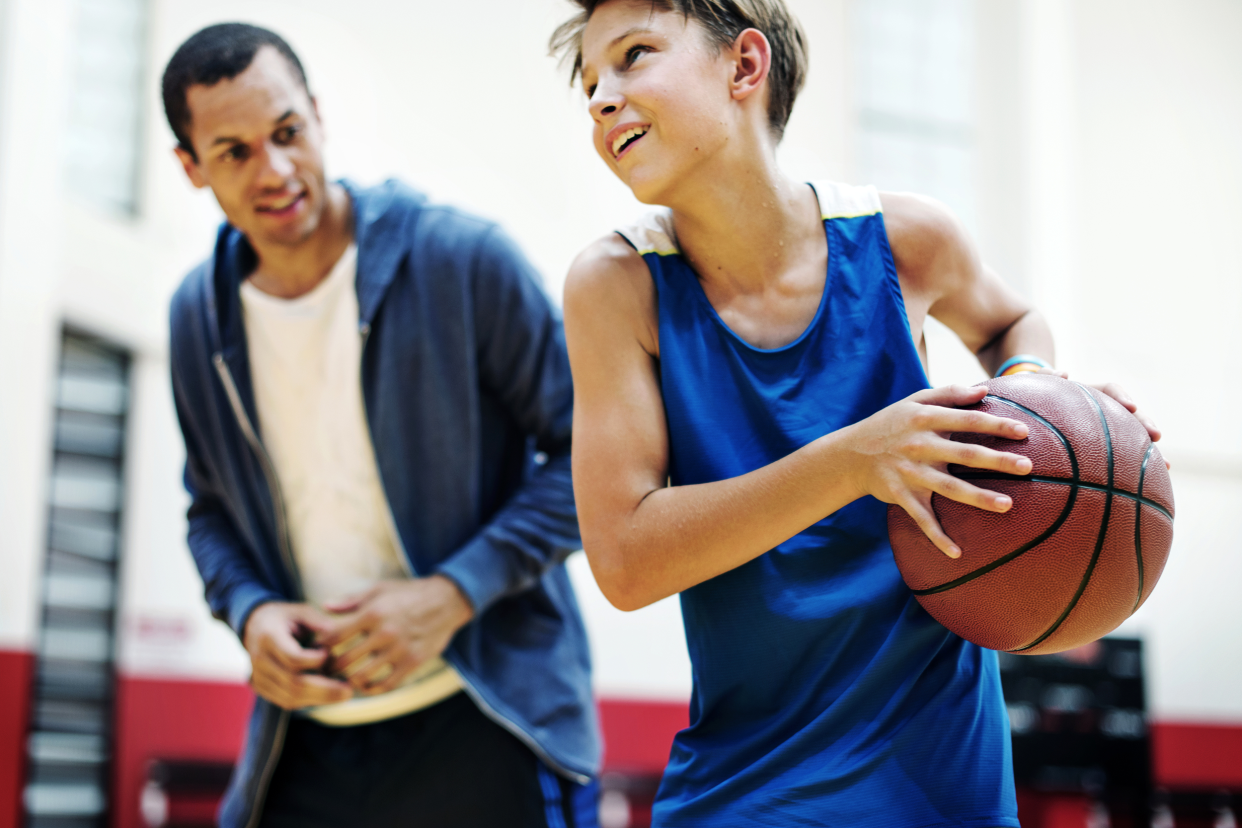 Kid playing basketball at school