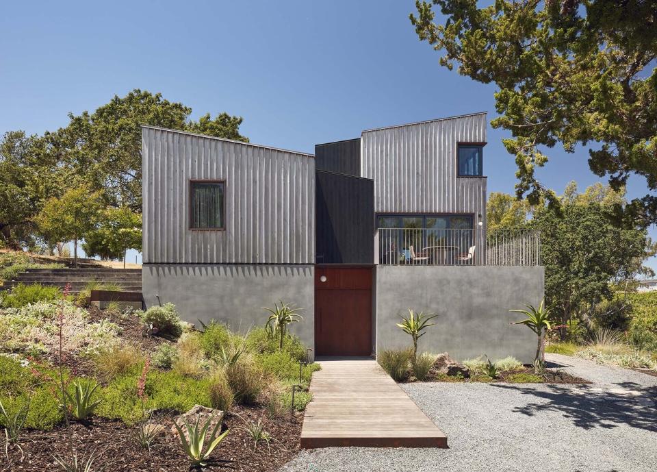 The mid-section of the siding was done in a shou-sugi ban method. Custom brass was used for the awning, alongside a standing-seam metal roof.