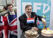 Britain's UK Independence Party (UKIP) MEP Ray Finch, right, celebrates the official triggering of Article 50 of the Lisbon Treaty in Brussels on Wednesday, March 29, 2017. EU Council President Donald Tusk has received a letter from British Prime Minister Theresa May, invoking Article 50 of the bloc's key treaty, the formal start of exit negotiations. (AP Photo/Thierry Monasse)