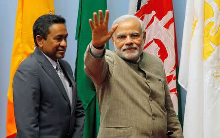 FILE PHOTO: India's Prime Minister Narendra Modi (R) waves as Maldives President Abdulla Yameen looks on during the closing session of 18th South Asian Association for Regional Cooperation (SAARC) summit in Kathmandu November 27, 2014. REUTERS/Niranjan Shrestha/Pool/File Photo