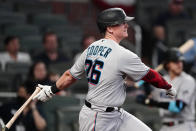 Miami Marlins' Garrett Cooper (26) drives in the go-ahead run with a single in the 10th inning of a baseball game against the Atlanta Braves, Monday, April 12, 2021, in Atlanta. (AP Photo/John Bazemore)