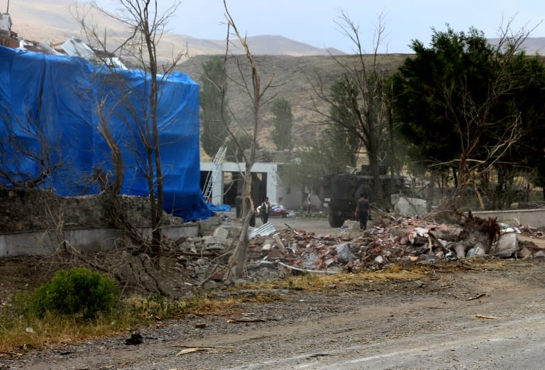 Wreckage lies on the ground in front of a Turkish millitary station covered by a tarpaulin after a suicide atack on August 2, 2015 in the eastern town of Dogubeyazit