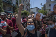 Angry demonstrators carry pictures of Nizar Banat, an outspoken critic of the Palestinian Authority, and chant anti-PA slogans during a rally protesting his death, in the West Bank city of Ramallah, Thursday, June 24, 2021. Banat who was a candidate in parliamentary elections called off earlier this year died after Palestinian security forces arrested him and beat him with batons on Thursday, his family said. (AP Photo/Nasser Nasser)