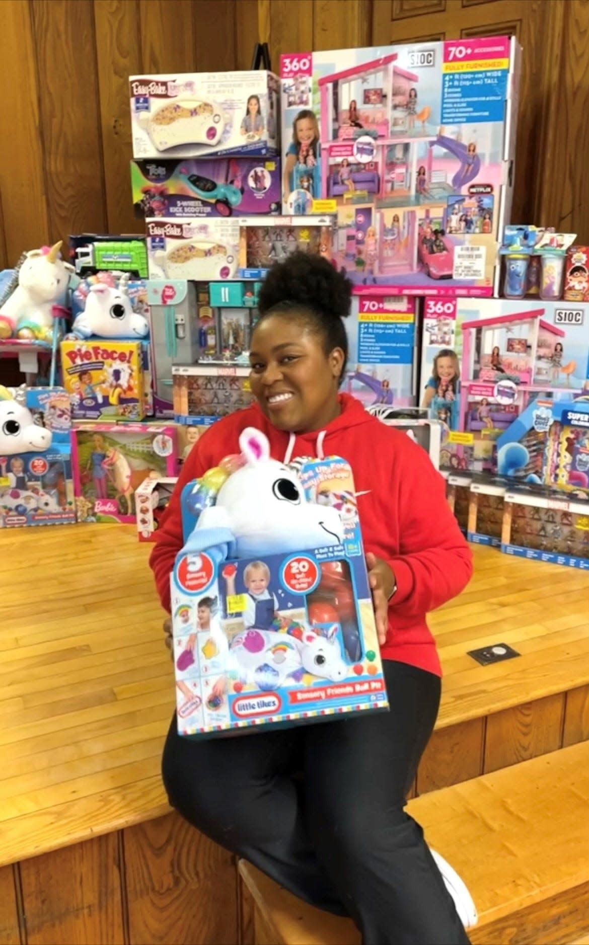 Sierra Cottle poses with the toys she donated to the Alliance YWCA's Christmas Outreach Program.