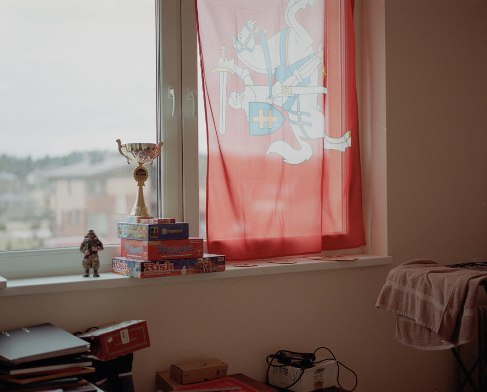 A historic Lithuanian National flag standing next to a toy soldier, games and a trophy, in Kaunas, Lithuania, on March 4.<span class="copyright">Tadas Kazakevicius for TIME</span>