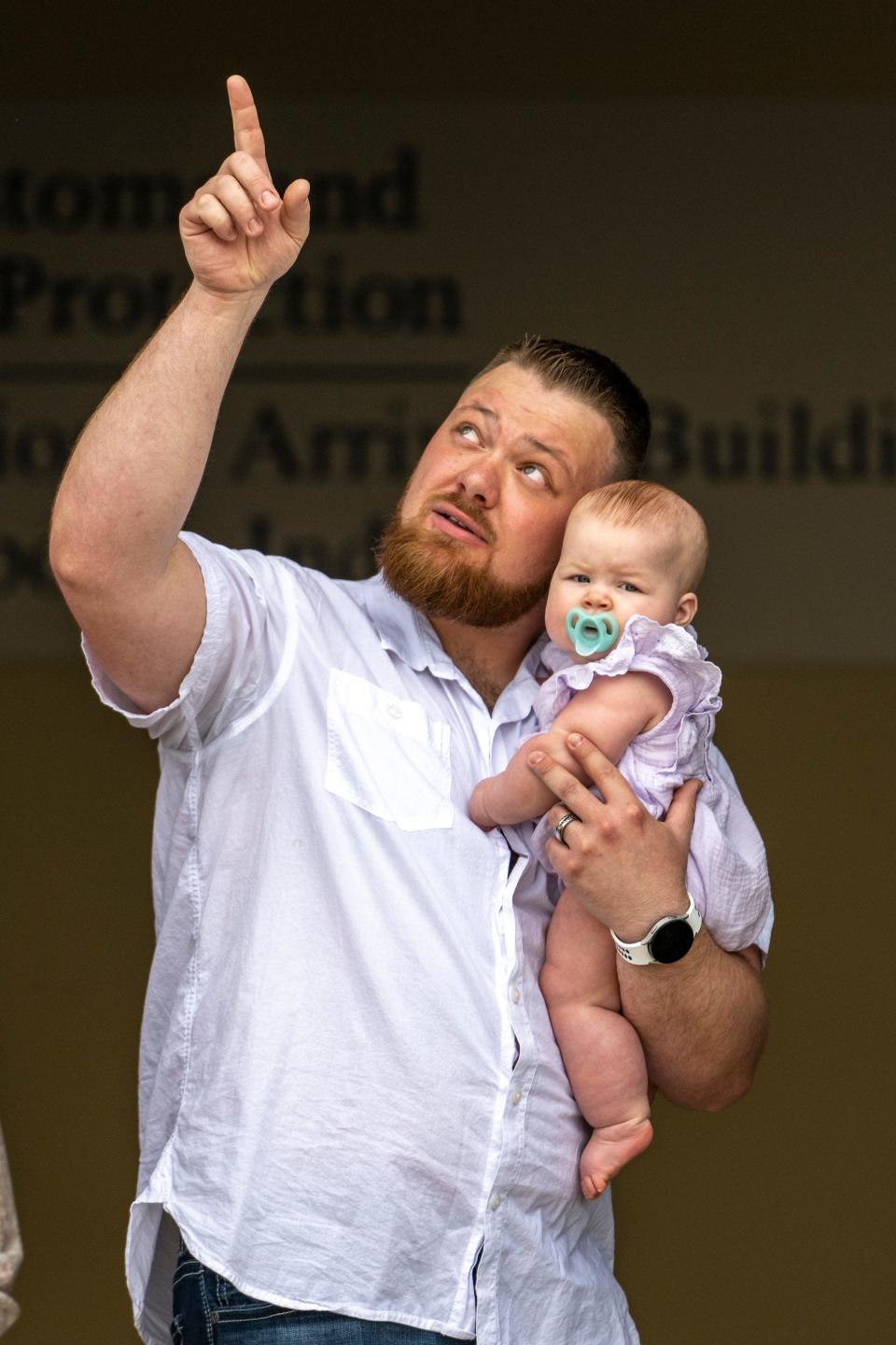 Steven Gendig, of Bargersville, holds his daughter, Ensley, as they await the arrival of a shipment of baby formula at the airport. The arrival of the first shipment of formula brought to the United States under Operation Fly Formula in response to the infant formula shortage caused by Abbott Nutrition’s voluntary recall arrived at the Indianapolis International Airport, Sunday, May 22, 2022, on a Air Force C-17.