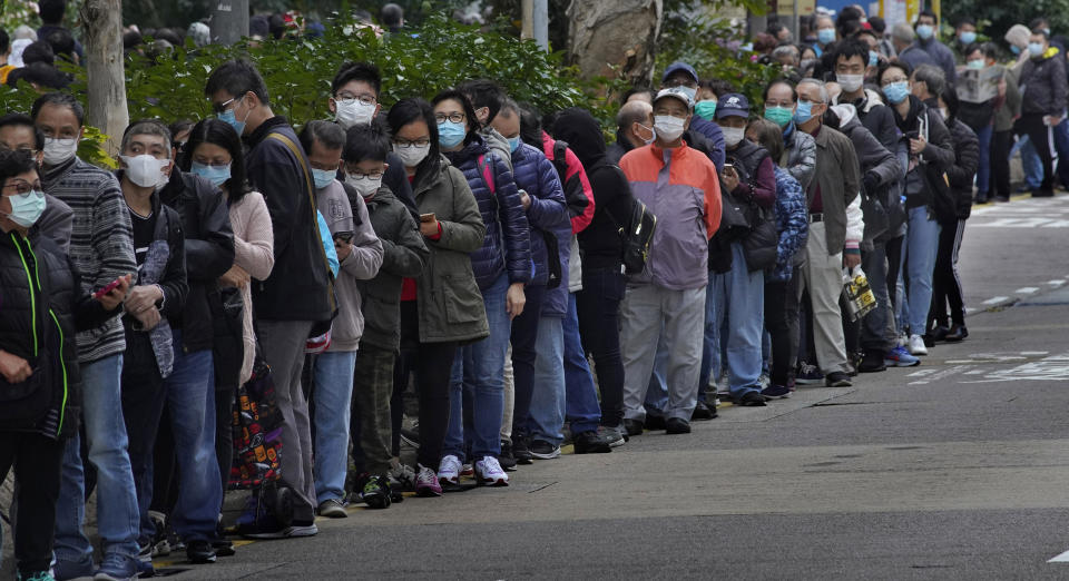 In this Feb. 5, 2020, photo, citizens line up to buy face masks in Hong Kong. The city's often-tumultuous street protests had already slowed in the past two months. Now they have ground to an almost complete halt as attention focuses on how to avoid a recurrence of the SARS pandemic, which killed about 300 people in Hong Kong in 2002-03. (AP Photo/Vincent Yu)