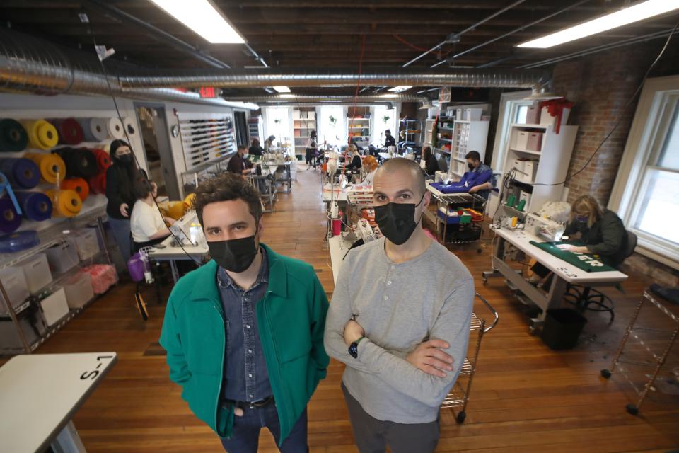 Oxford Pennant co-founders Brett Mikoll, left, and Dave Horesh, right, stand on the sewing floor in their company's manufacturing building in downtown Buffalo on Wednesday, Feb. 8, 2022.