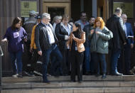 Embassy staff gather before some of them will leave the Czech Republic Embassy in Moscow, Russia, Monday, April 19, 2021. Russia has ordered 20 Czech diplomats to leave the country within a day in response to Prague's expulsion of 18 Russian diplomats. The Czech government has alleged the Russian Embassy staffers were spies for a military intelligence agency that was involved in a fatal ammunition depot explosion in 2014. (AP Photo/Pavel Golovkin)