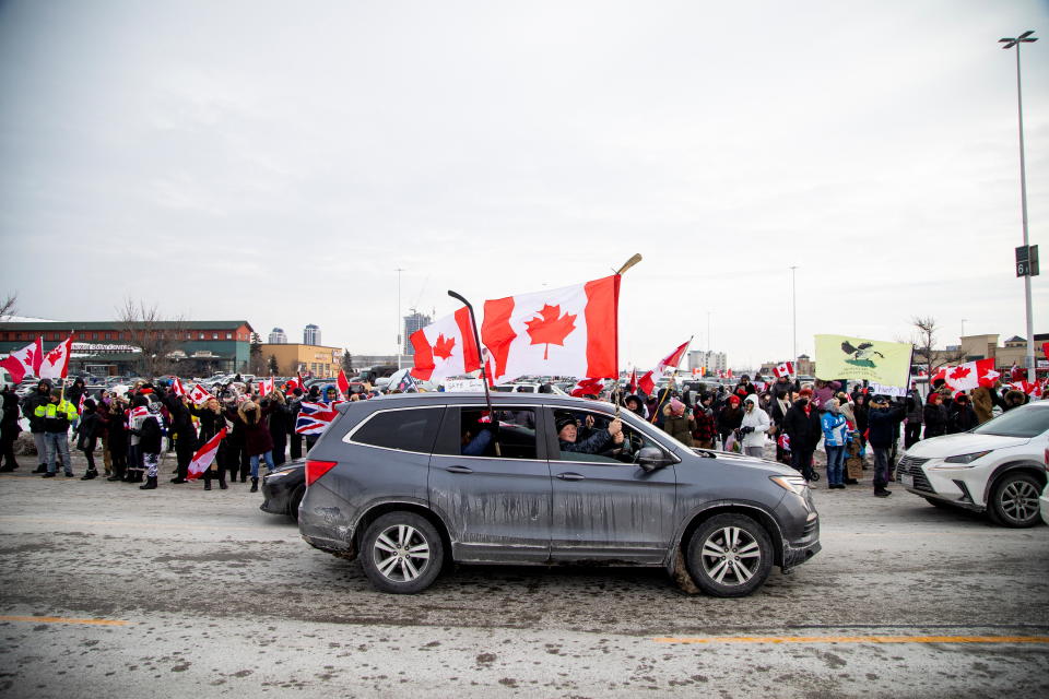 People gather to support truck drivers on their way to Ottawa in protest of coronavirus disease (COVID-19) vaccine mandates for cross-border truck drivers, in Toronto, Ontario, Canada, January 27, 2022. REUTERS/Carlos Osorio  