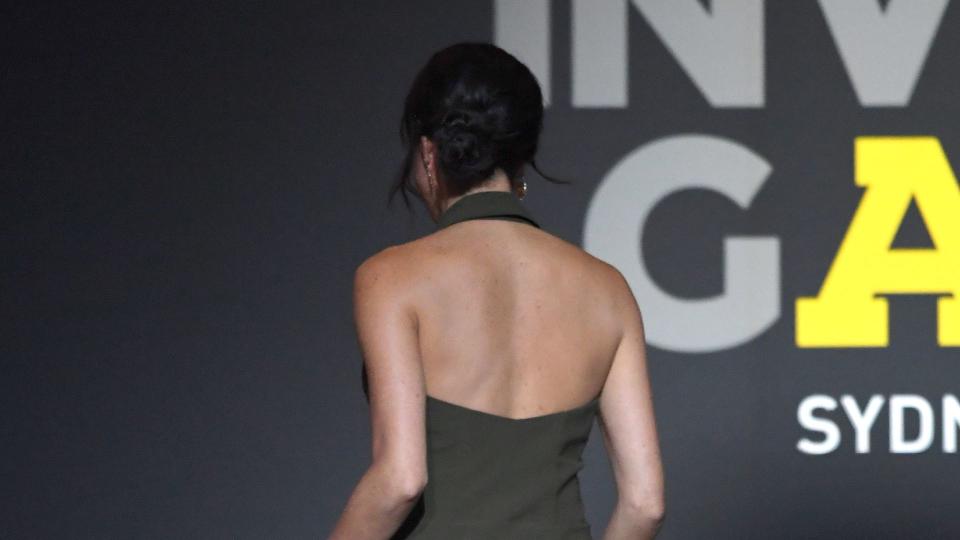 Meghan Markle wearing a stunning backless khaki dress in 2018