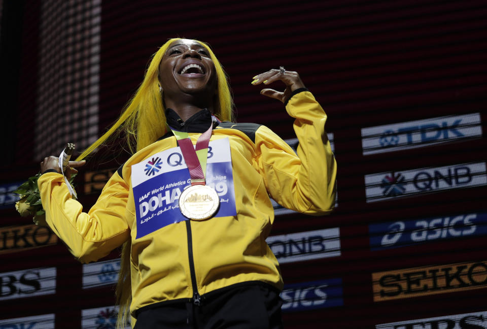 Shelly-Ann Fraser-Pryce of Jamaica, gold medalist in the women's 100 meters, reacts during the medal ceremony at the World Athletics Championships in Doha, Qatar, Monday, Sept. 30, 2019. (AP Photo/Nariman El-Mofty)