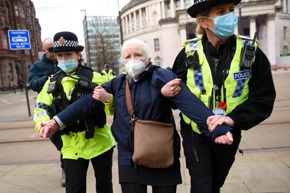 Police detain a woman after breaking up a protest in ManchesterPA Wire