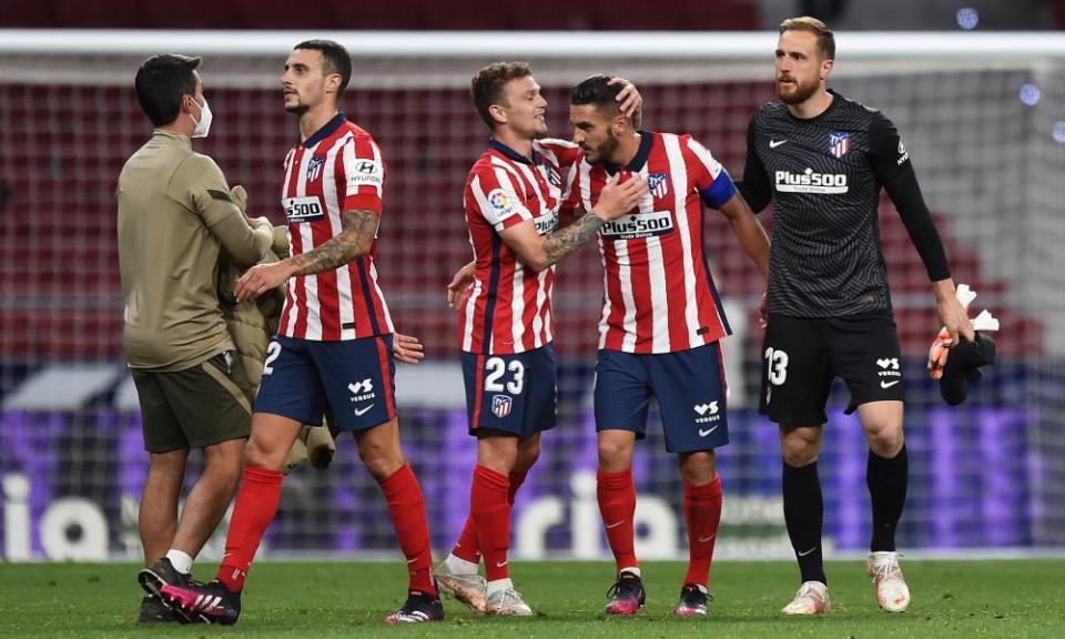 Kieran Trippier (centre) and Koke embrace at the final whistle.