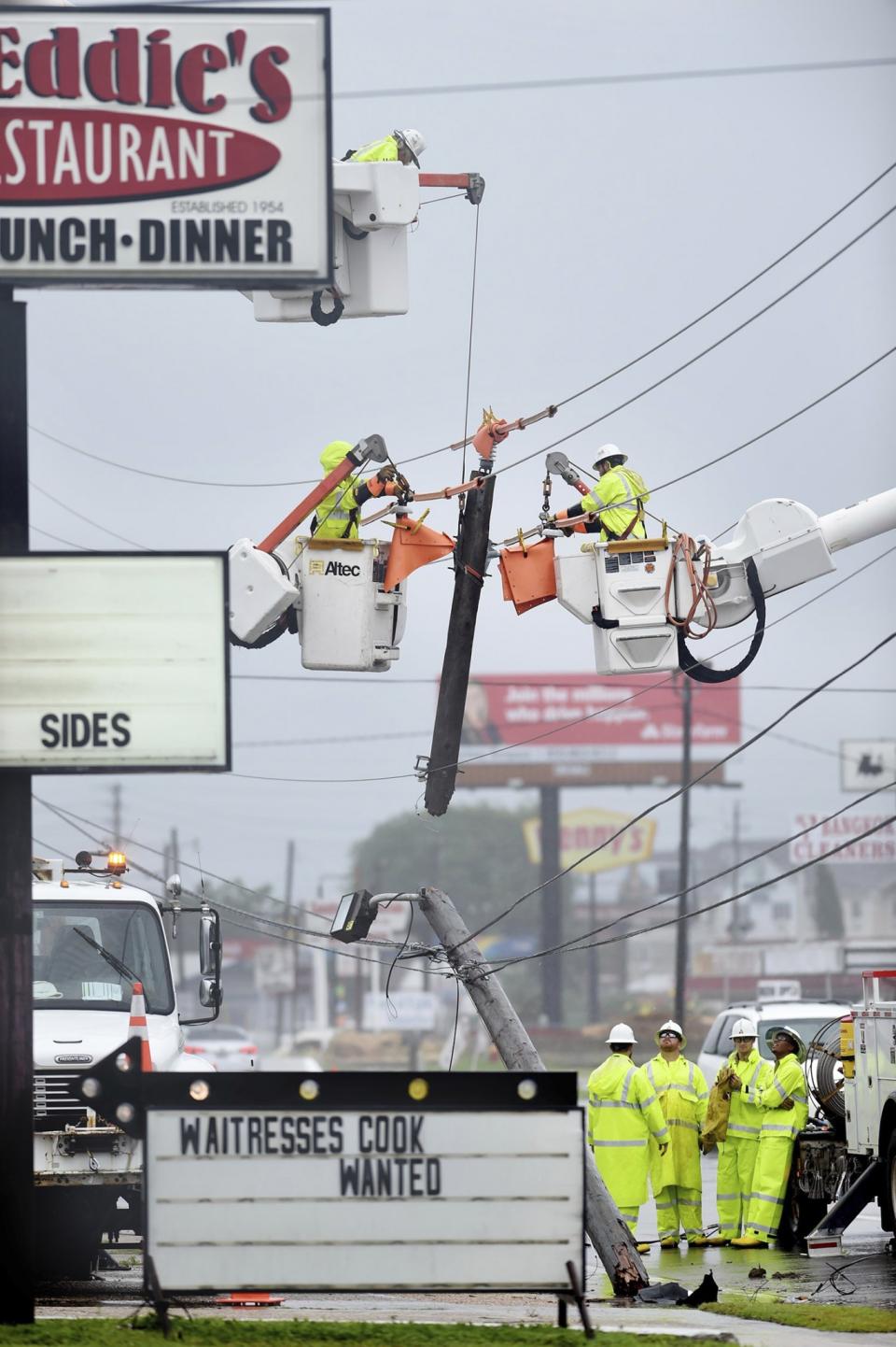 <p>Gulf Power employees repair a power pole that snapped, June 21, 2017, in Fort Walton Beach, Fla. A line of severe weather from Tropical Storm Cindy battered this northwest Florida community early Wednesday morning. (Photo: Devon Ravine/Northwest Florida Daily News via AP) </p>