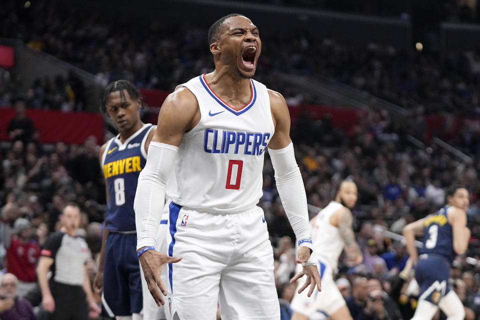 Los Angeles Clippers guard Russell Westbrook, second from left, celebrates after dunking as Denver Nuggets forward Peyton Watson, left, looks on during the second half of an NBA basketball game Thursday, April 4, 2024, in Los Angeles. (AP Photo/Mark J. Terrill)