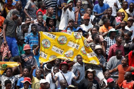 Mourners sing before paying their last respects to Former Zimbabwean president Robert Mugabe as he lies in state at the at Rufaro stadium, in Mbare,