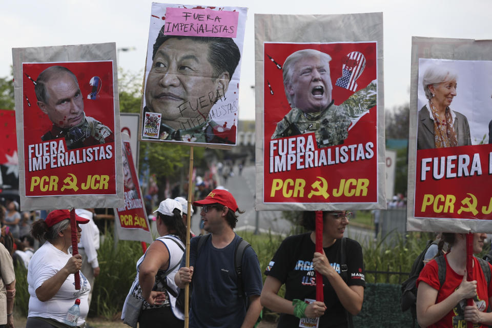 Protesters with signs of the face of, from left, Russia’s President Vladimir Putin, China’s President Xi Jinping, President Donald Trump and IMF Managing Director Christine Lagarde, covered by the Spanish phrase “Get out imperialists!,” march against the G20 summit being held in Buenos Aires, Argentina, Friday, Nov. 30, 2018. Leaders from the Group of 20 industrialized nations are meeting in Buenos Aires for two days starting today. (Photo: Martin Mejia/AP)