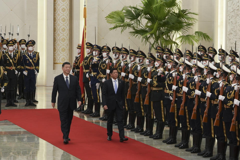 In this photo provided by the Philippines Office of the Press Secretary, Philippine President Ferdinand Marcos Jr., right, and President Xi Jinping review an honor guard during a welcome ceremony at the Great Hall of the People in Beijing, Wednesday, Jan. 4, 2023. Marcos is pushing for closer economic ties on a visit to China that seeks to sidestep territorial disputes in the South China Sea. (Philippines Office of the Press Secretary via AP)