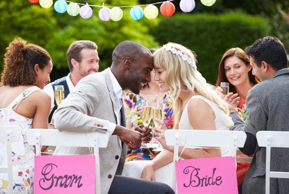 Bride and groom enjoying meal at wedding reception